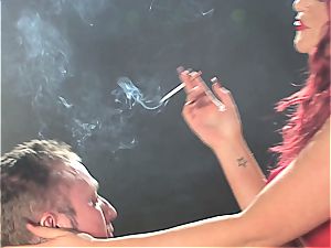redhead slut dominates a stud while smoking